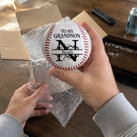 Customer photo of a personalized baseball for his grandson Noah, held above the opened gift box